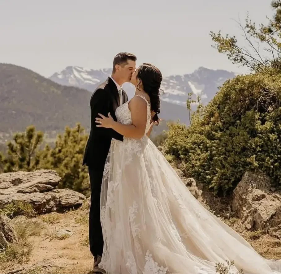 Сouple wearing a white gown and a black suit