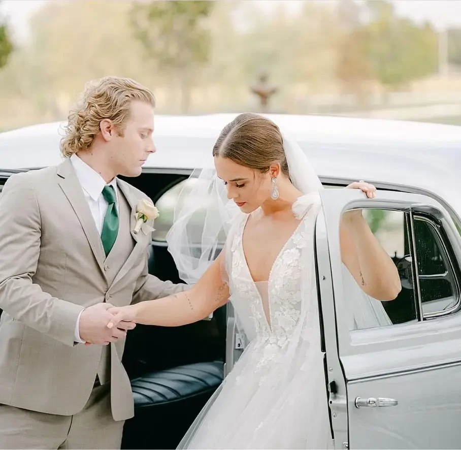 Сouple wearing a white gown and a black suit